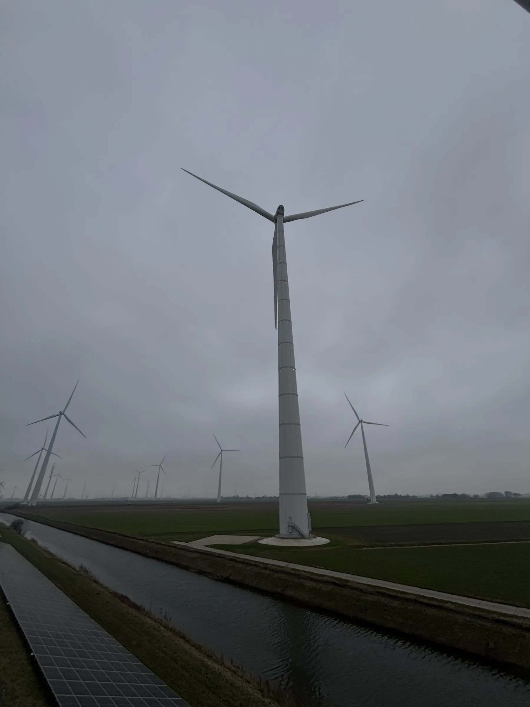 Wind turbine beside a canal in the Netherlands
