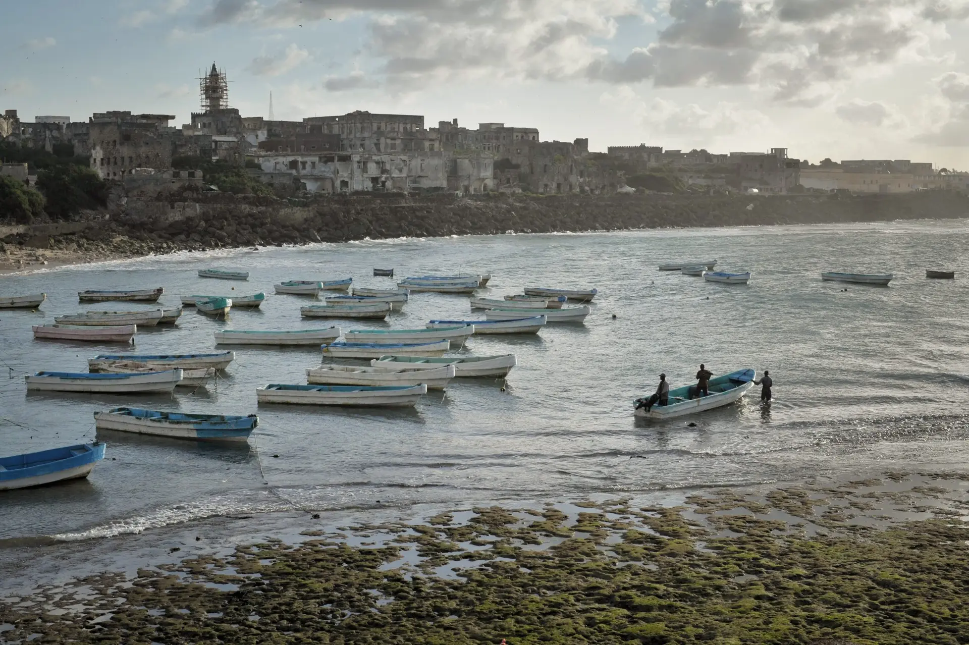 Sunrise over Mogadishu's old port with fishing boats
