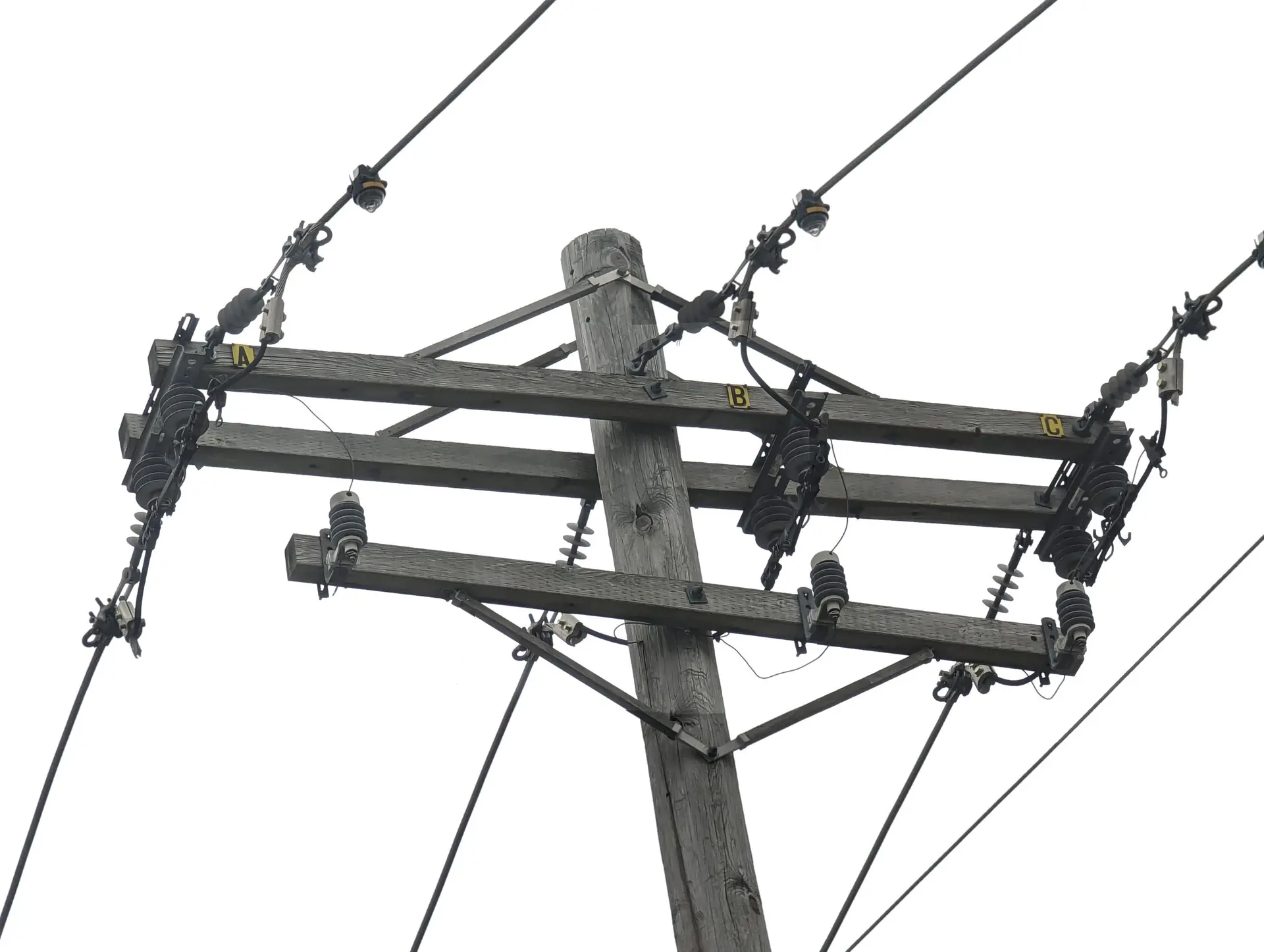 Top of a power pole carrying a three-phase distribution line