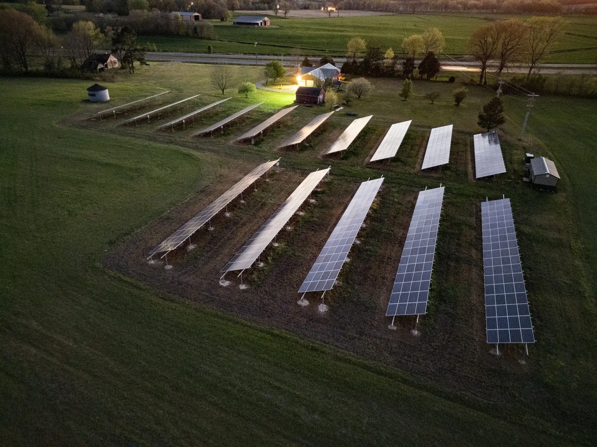 Aerial view of a solar farm at dusk