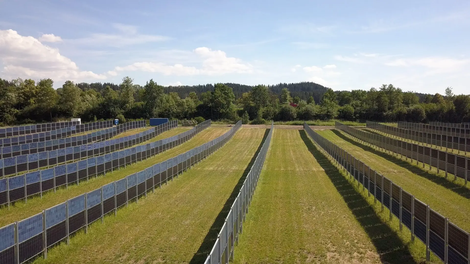 Aerial view of rows of solar panels across fields