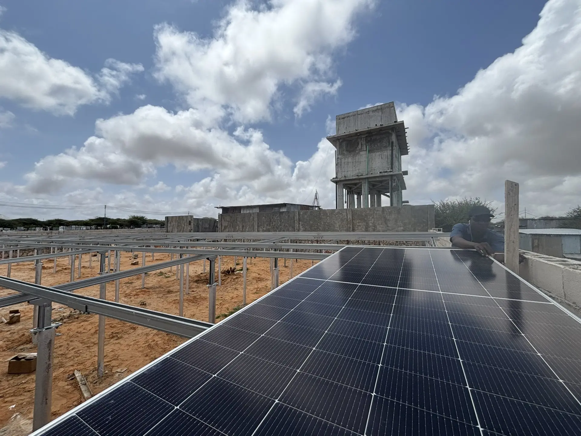 Solar array beside a water tower