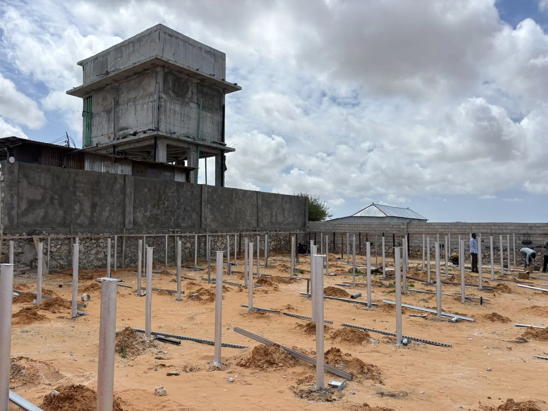 Solar mounting piles beside a water tower