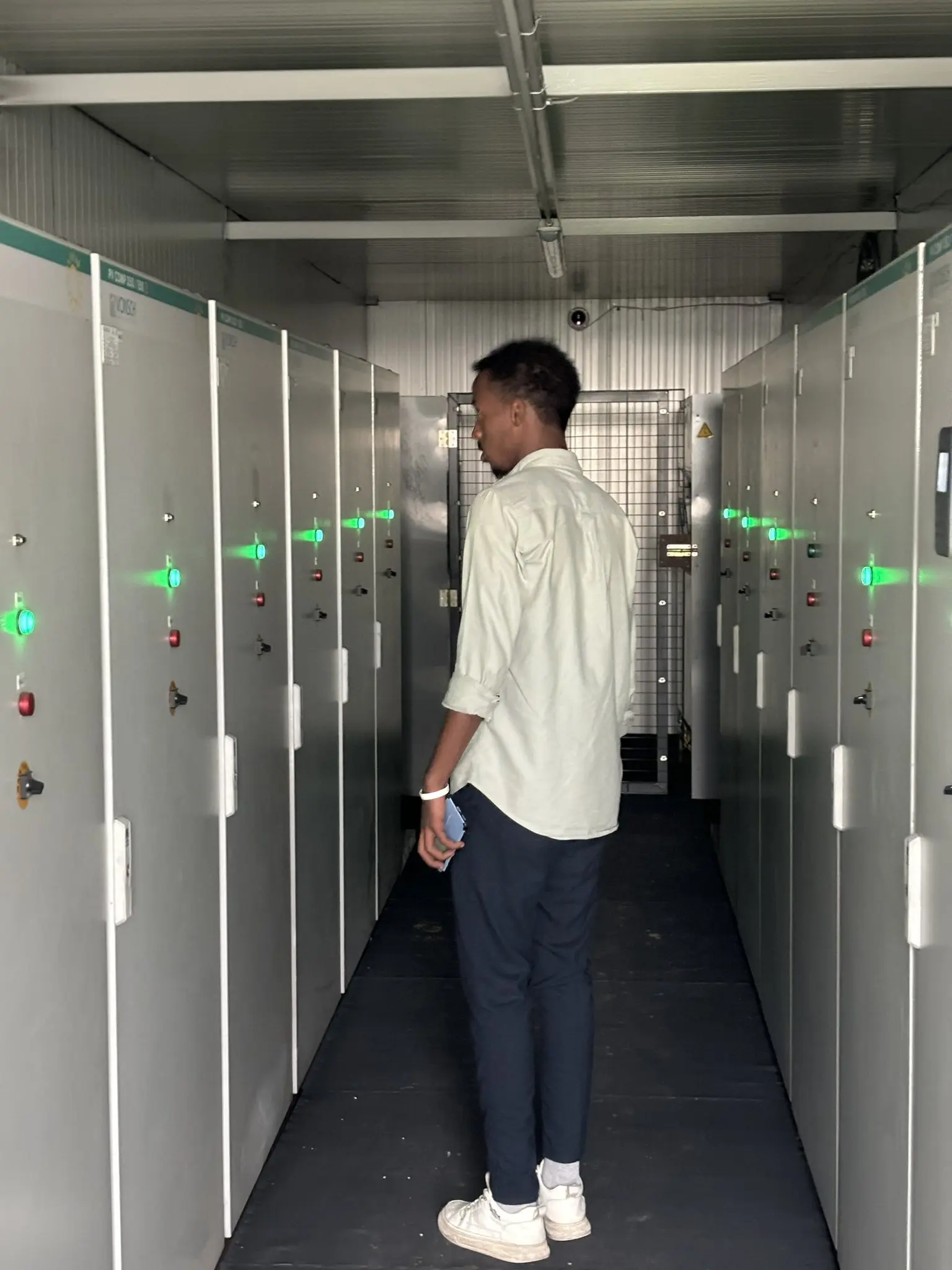 Engineer in the aisle of a battery energy storage container