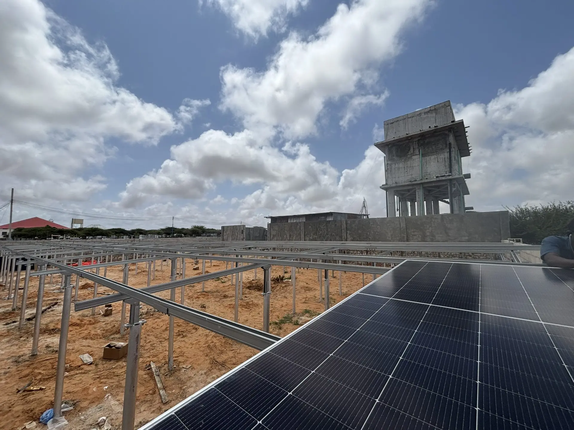 Solar panels in front of a water tower